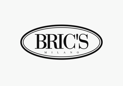 BRIC's collection of premium toiletry bags in black, lavender, and brown for corporate gift giving.