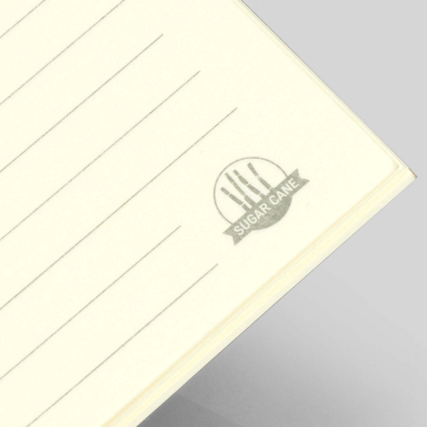 Sugarcane Paper Soft Cover Notebook showing lined pages and unique sugarcane logo on the corner.