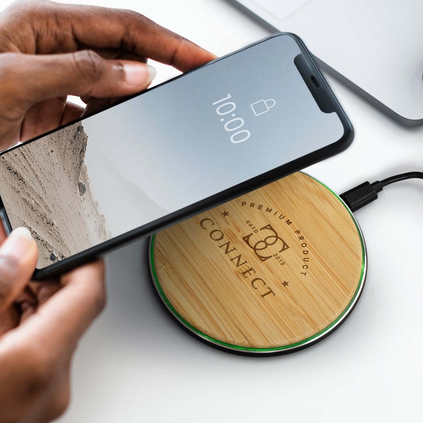 Bamboo 15W Wireless Fast Charger with phone charging on natural bamboo pad.