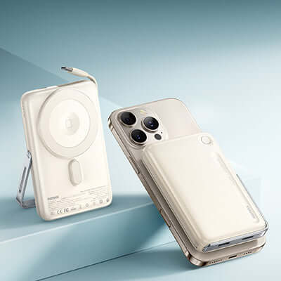Remax MC-05 Magnetic Wireless Charging Powerbank with Stand next to a smartphone on a smooth surface.
