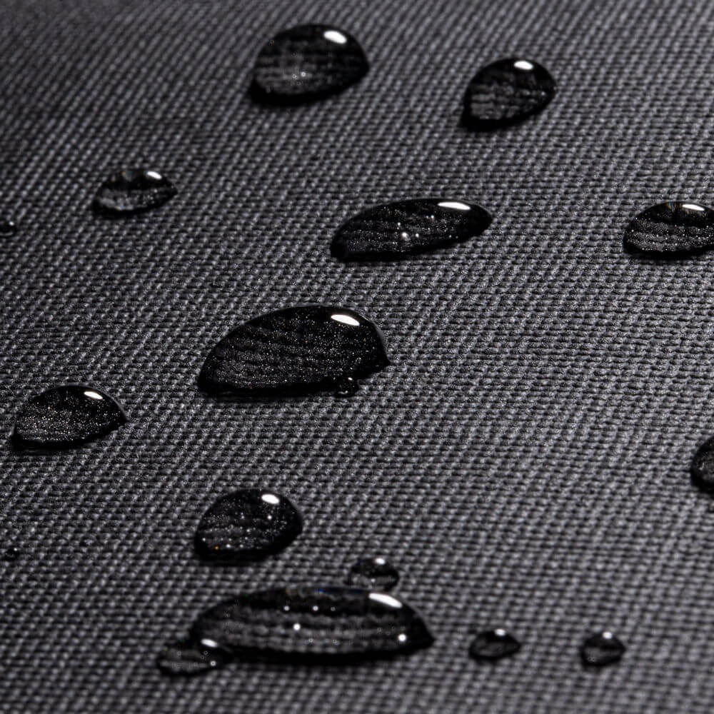 Close-up of water droplets on the waterproof material of the Rivacase Cardiff Canvas Crossbody Bag with Adjustable Strap.