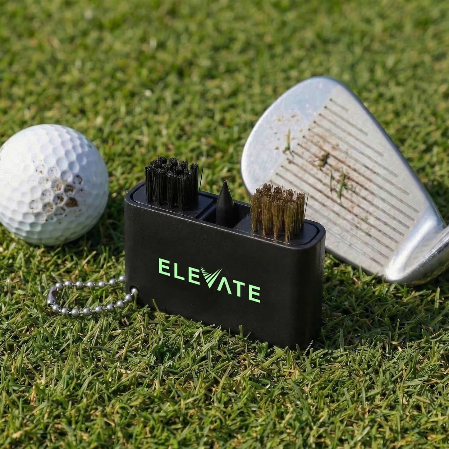 Caddie Golf Club Cleaning Tool shown with golf ball and club on grass, ideal for corporate gift use.
