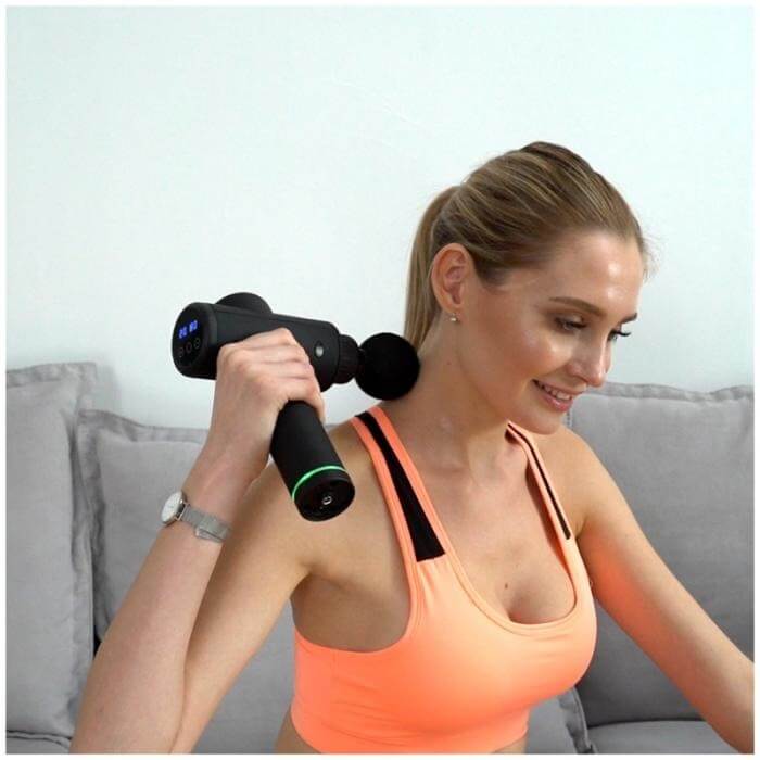 Woman using Prixton MGF200 Xtreme Massage Gun for muscle relaxation and recovery.