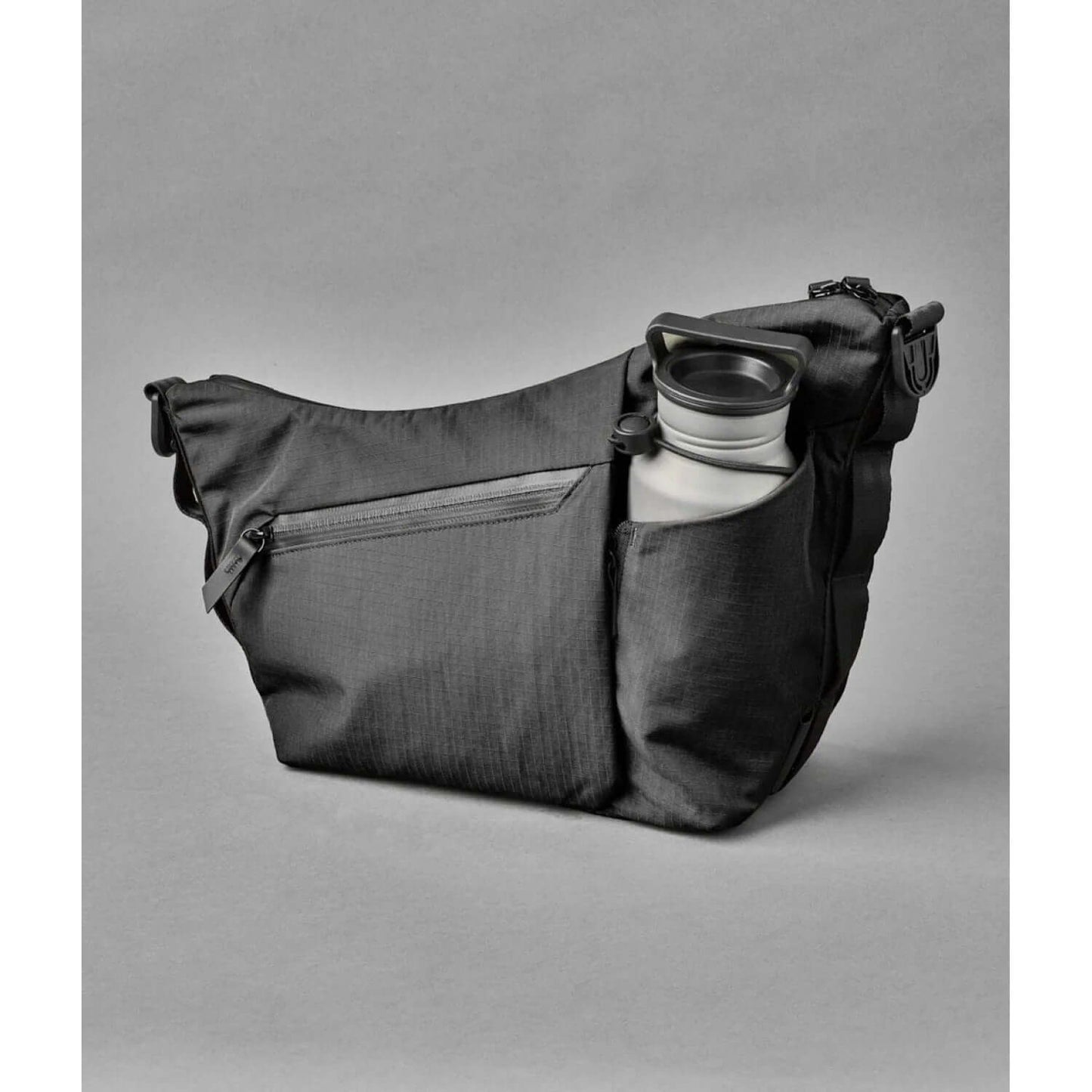 ALPAKA Flow Satchel Sling Bag with integrated bottle sleeve for hydration and organized storage