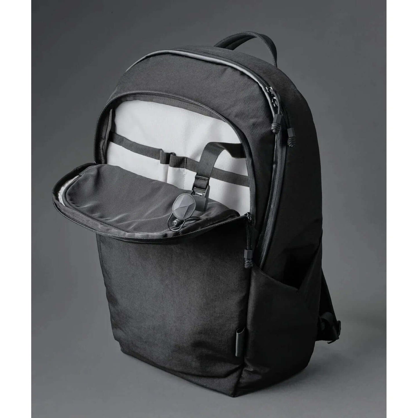 ALPAKA Bravo Backpack 23L black interior view with open compartment and organizational features.