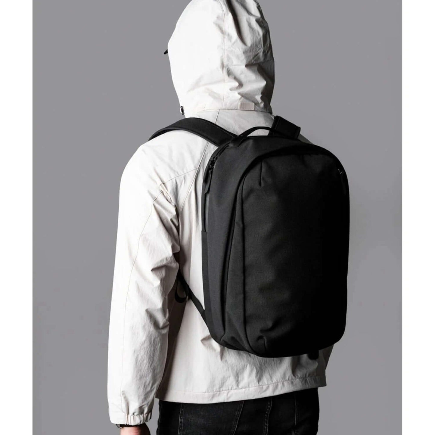 ALPAKA Metro Backpack Pro worn by a person in a light jacket, showcasing its sleek design and functionality.