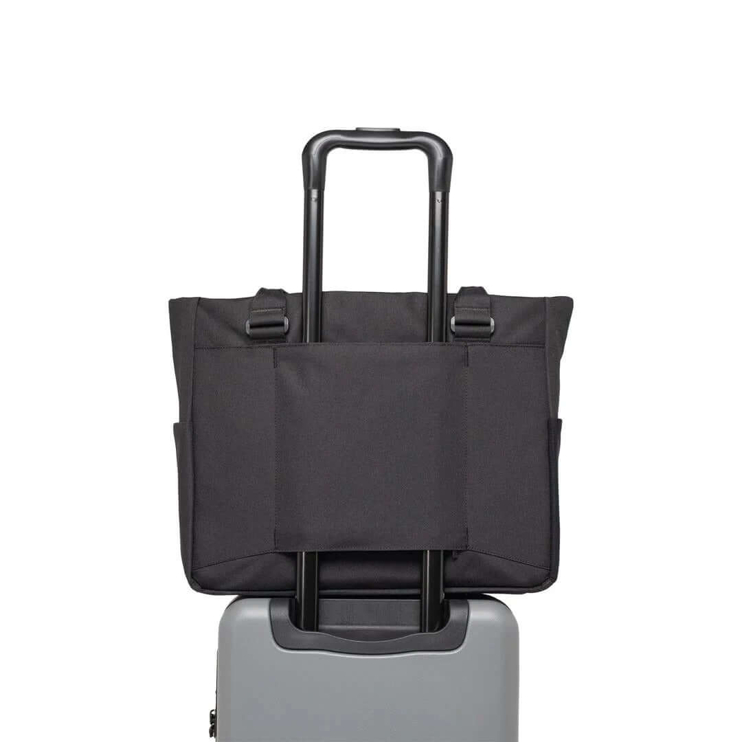 Herschel Kaslo Tote Tech Bag shown mounted on a suitcase, ideal for corporate gift for travelers.