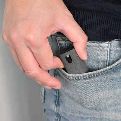 Person taking out the BrandCharger Spare 3 in 1 Sanitizer Case from their jeans pocket.