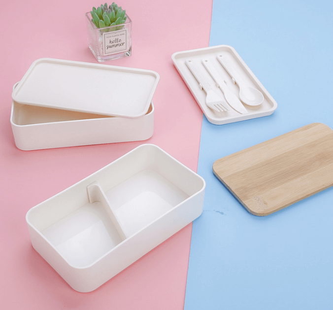 2-tier Lunchbox with Cutlery Set and Bamboo lid in beige color on a pastel background
