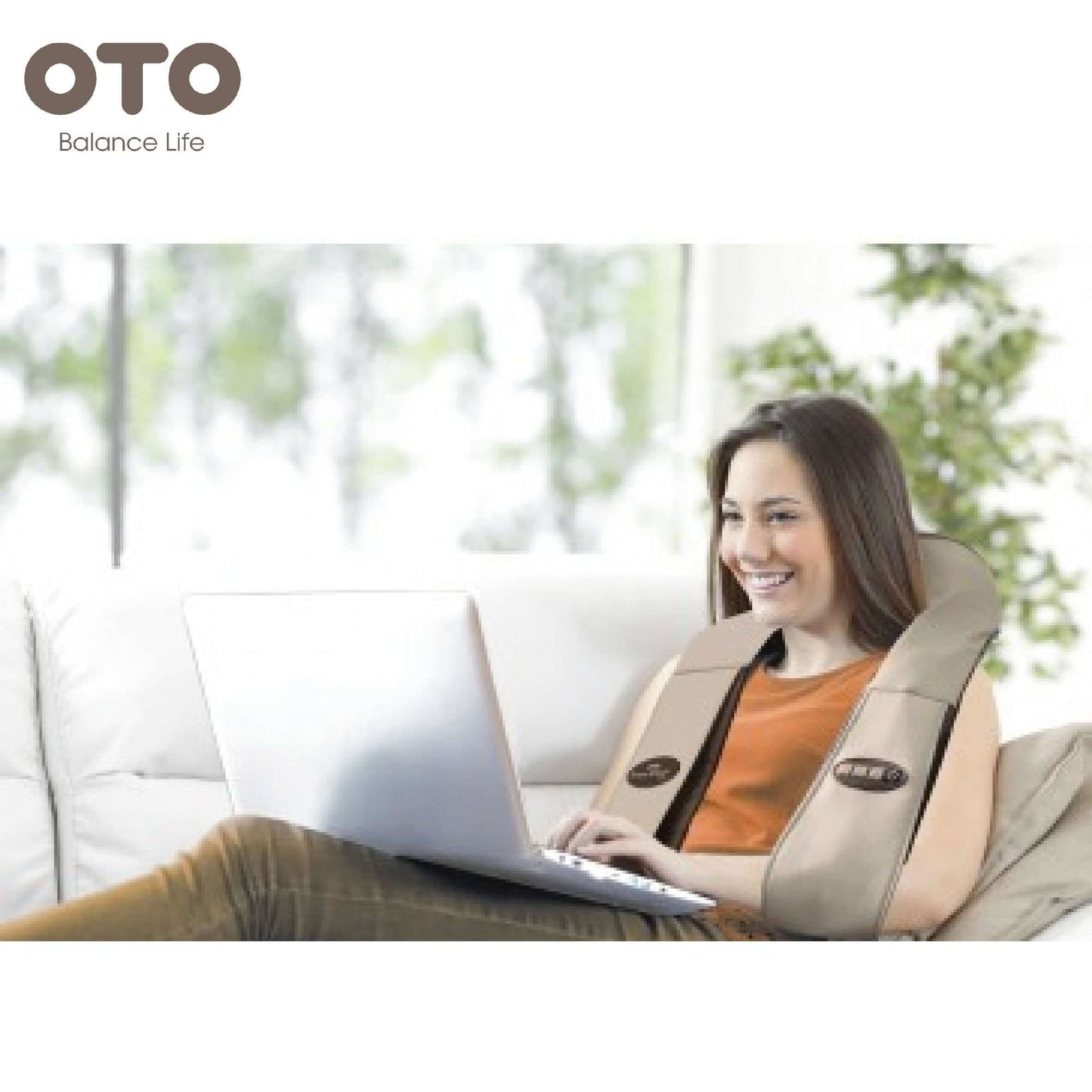 Woman using OTO Power Wrap massage device while working on a laptop, promoting relaxation and comfort.