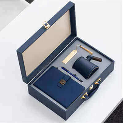 The Perfect Corporate Gifts for Professionals: Impress with Purpose - luxury gift set with notebook, pen, and mug in blue box.