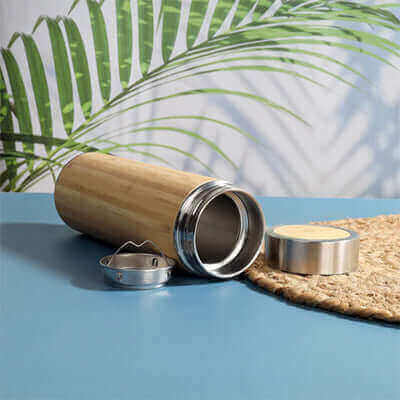 Corporate Gift Flasks: The Perfect Blend of Style and Utility with a bamboo flask on a table.