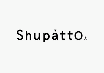 Woman holding a floral Shupatto bag from the Shupatto Bags Collection, perfect for corporate gifts and daily use.