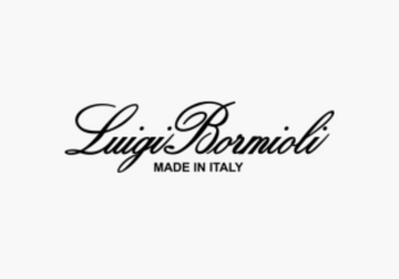 Woman enjoying red wine in a Luigi Bormioli glass, highlighting elegant corporate gift options.
