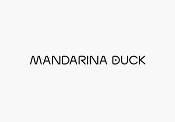 Three colorful Mandarina Duck bags in red, yellow, and blue against a pastel background for stylish travel.