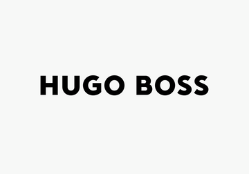 Hugo Boss black wallet held in hand, a stylish corporate gift for visionaries and achievers.