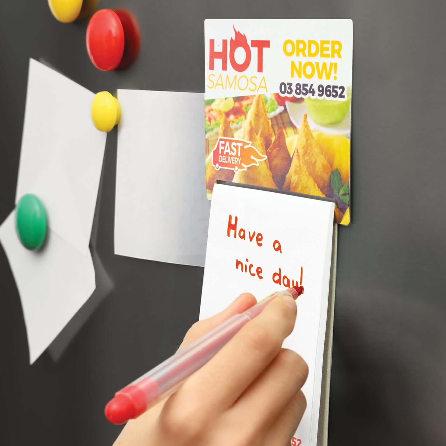 Hand writing on Magnetic Memo Pad A7 - Full Colour attached to fridge with food advertisement.