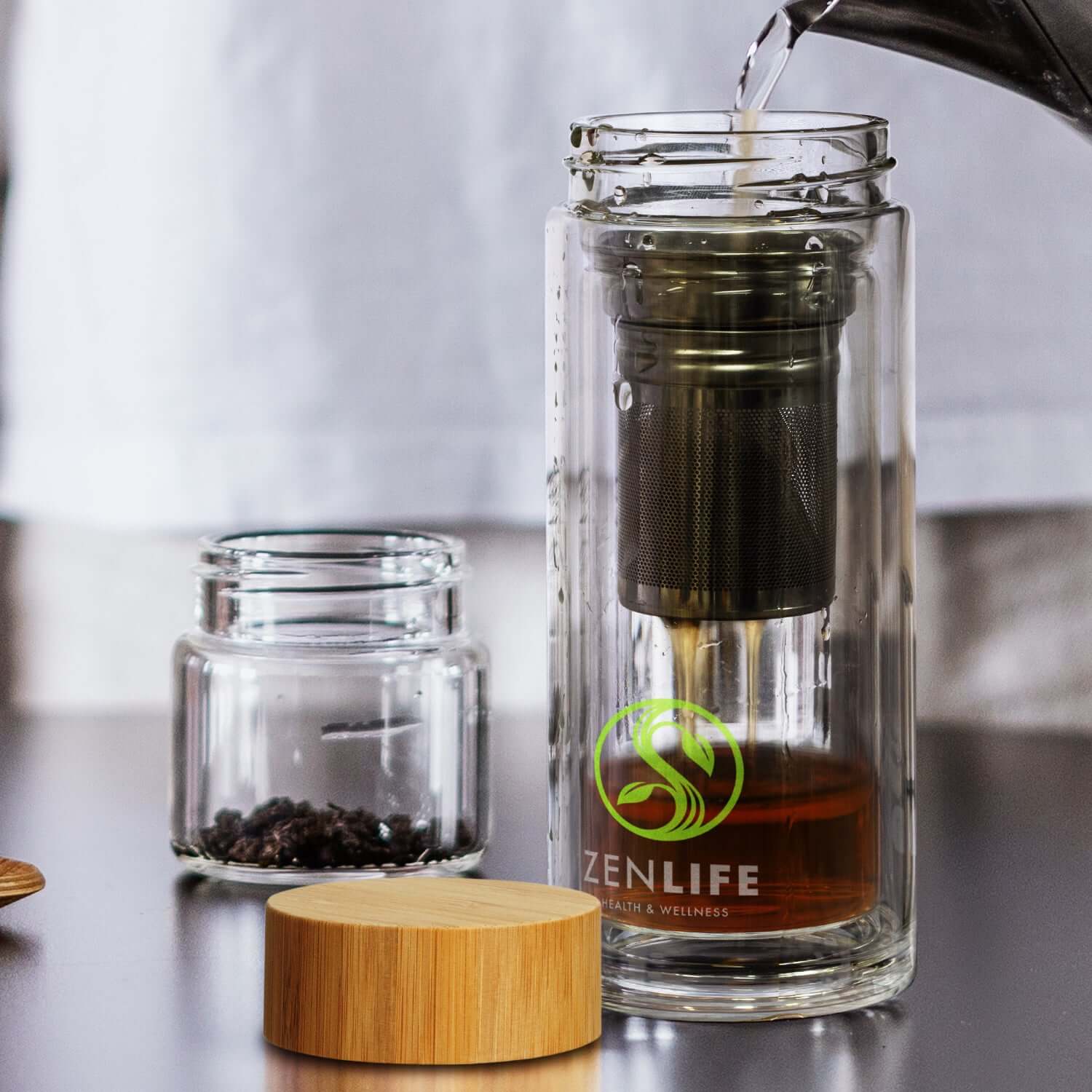 Tea Infuser Bottle being used to brew tea with a bamboo lid and infuser, perfect for corporate gifts.