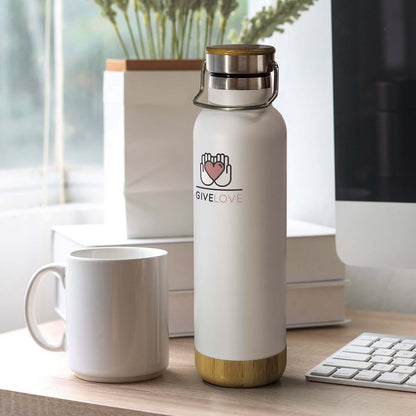Nomad Vacuum Bottle - Bambino on a desk next to a white mug, showcasing its stylish design for everyday use.