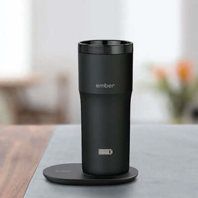Ember Travel Mug 2 12oz on charging coaster, perfect for a corporate gift with temperature control features.