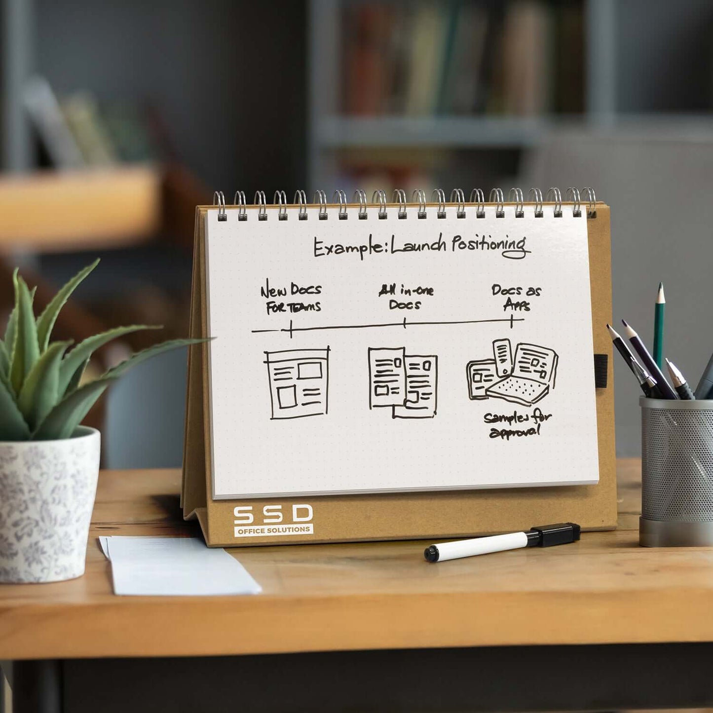 Desk Whiteboard Notebook enhancing organization with sketches on a bamboo desk in a workspace.