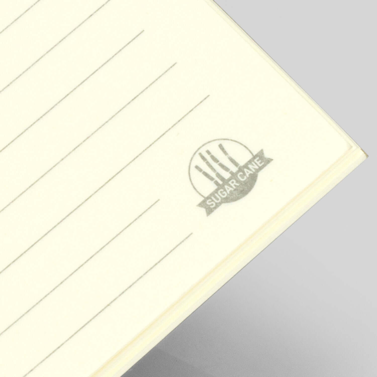 Sugarcane Paper Soft Cover Notebook showing lined pages and unique sugarcane logo on the corner.