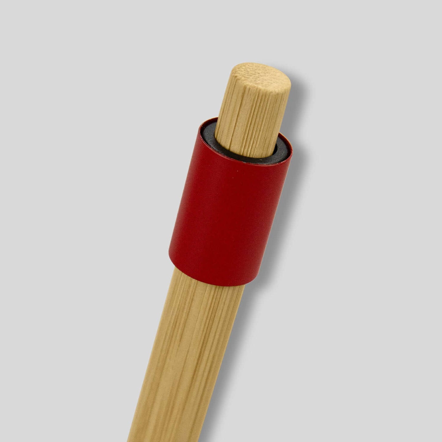 Unwind Bamboo Spinner Pen with natural bamboo barrel and red aluminum fidget spinner ring, perfect corporate gift.