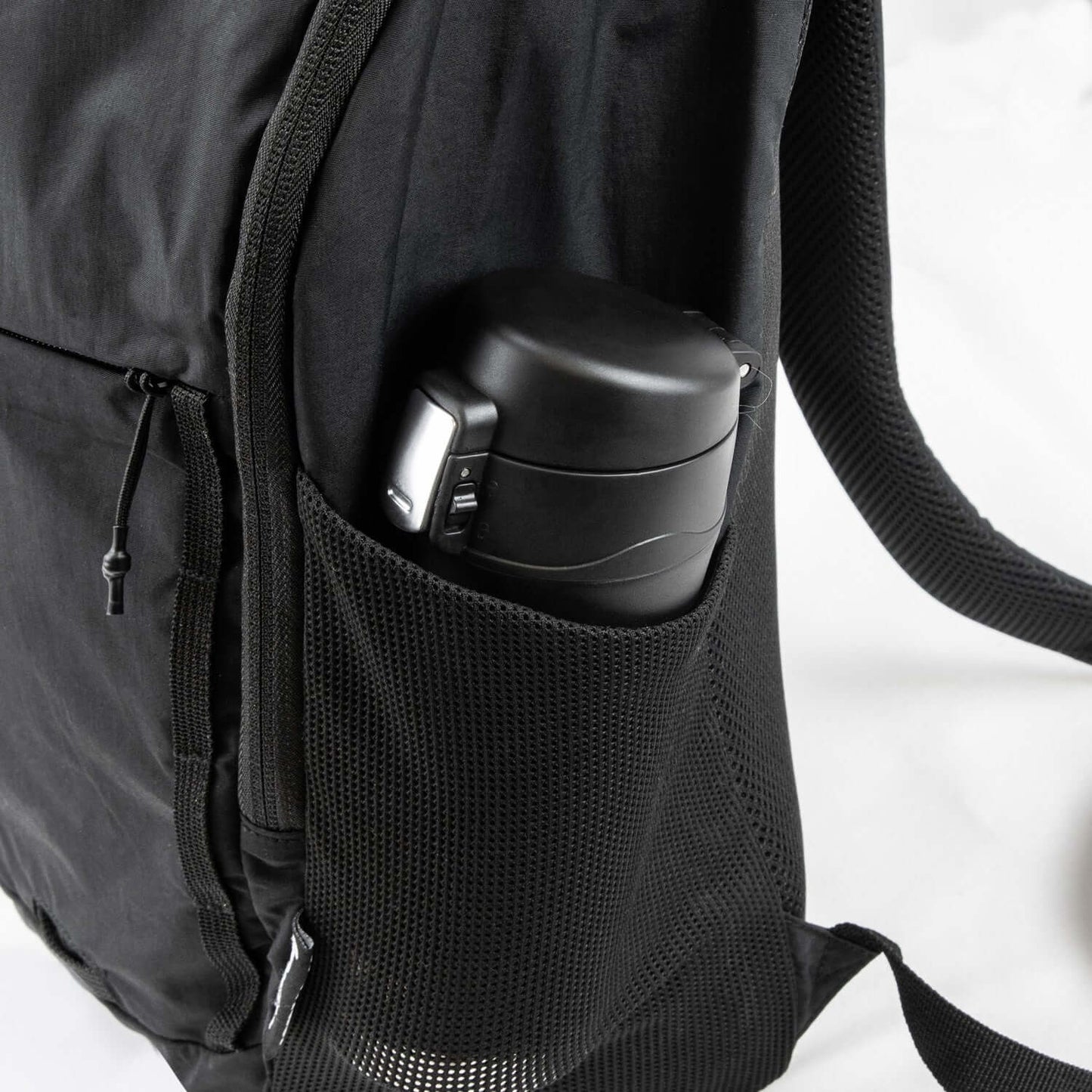 Frontier Trail Daypack side pocket holding a black insulated bottle, showcasing practical outdoor features