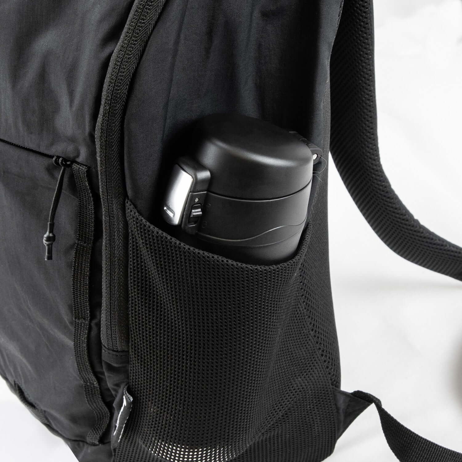 Frontier Trail Daypack side pocket holding a black insulated bottle, showcasing practical outdoor features