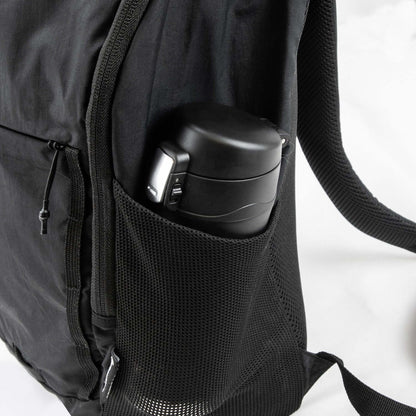 Frontier Trail Daypack side pocket holding a black insulated bottle, showcasing practical outdoor features