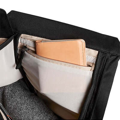Interior view of the Bellroy Melbourne Backpack Compact showing organizational pockets and a leather notebook.