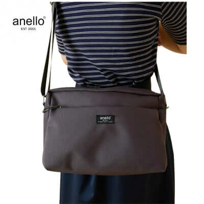 Anello Parcel Shoulder Bag worn by a person, showcasing its stylish design and functional features.
