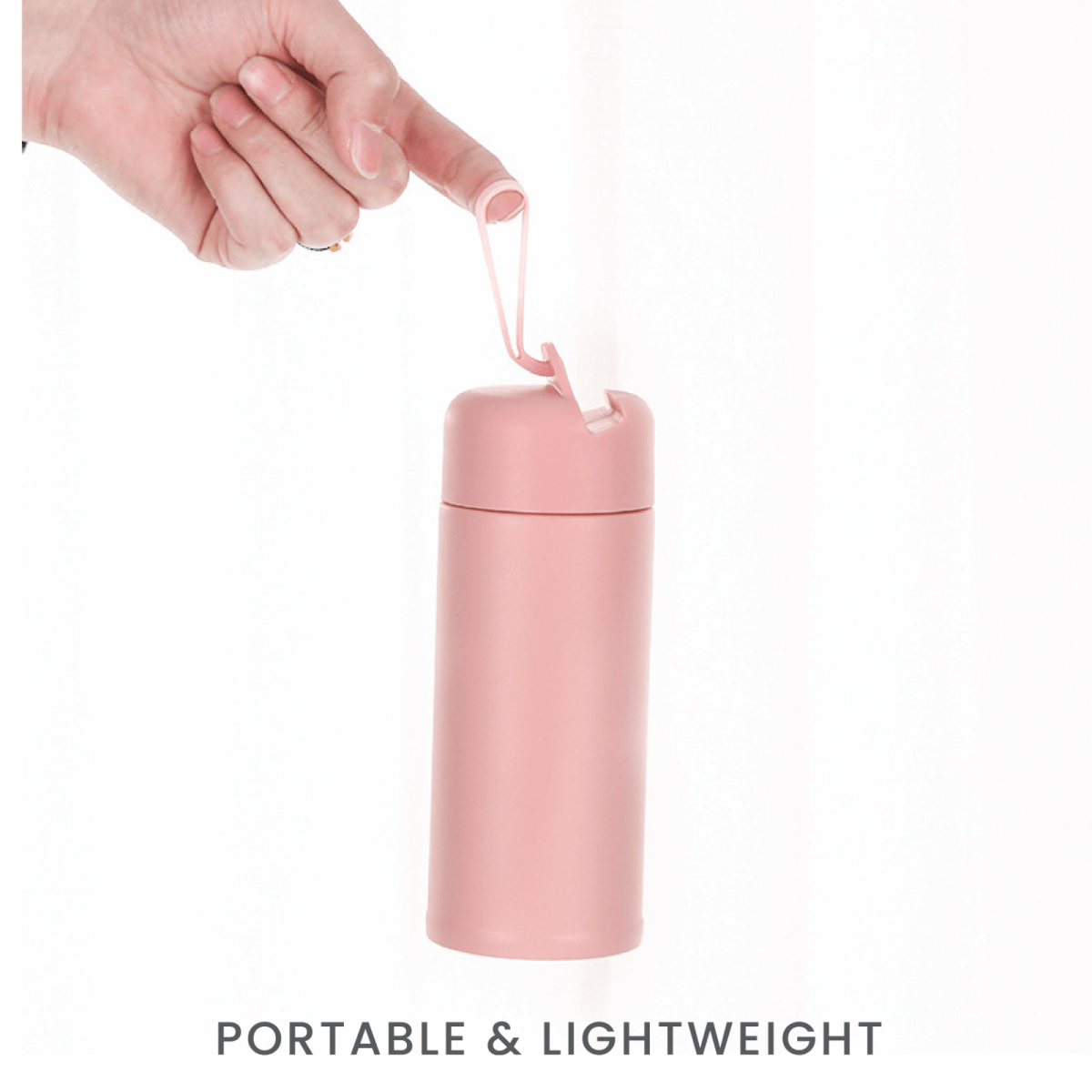 Mobi 350ml Vacuum Flask in pink being held, showcasing its portable and lightweight design.