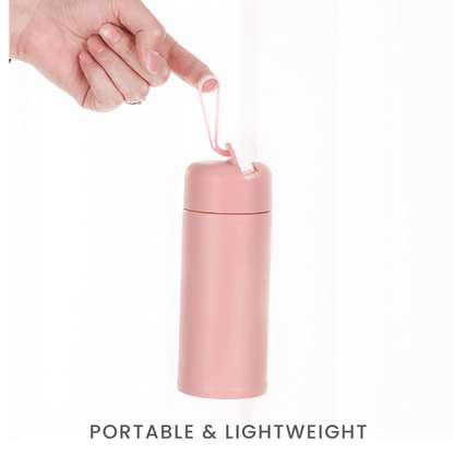 Mobi 350ml Vacuum Flask in pink being held, showcasing its portable and lightweight design.