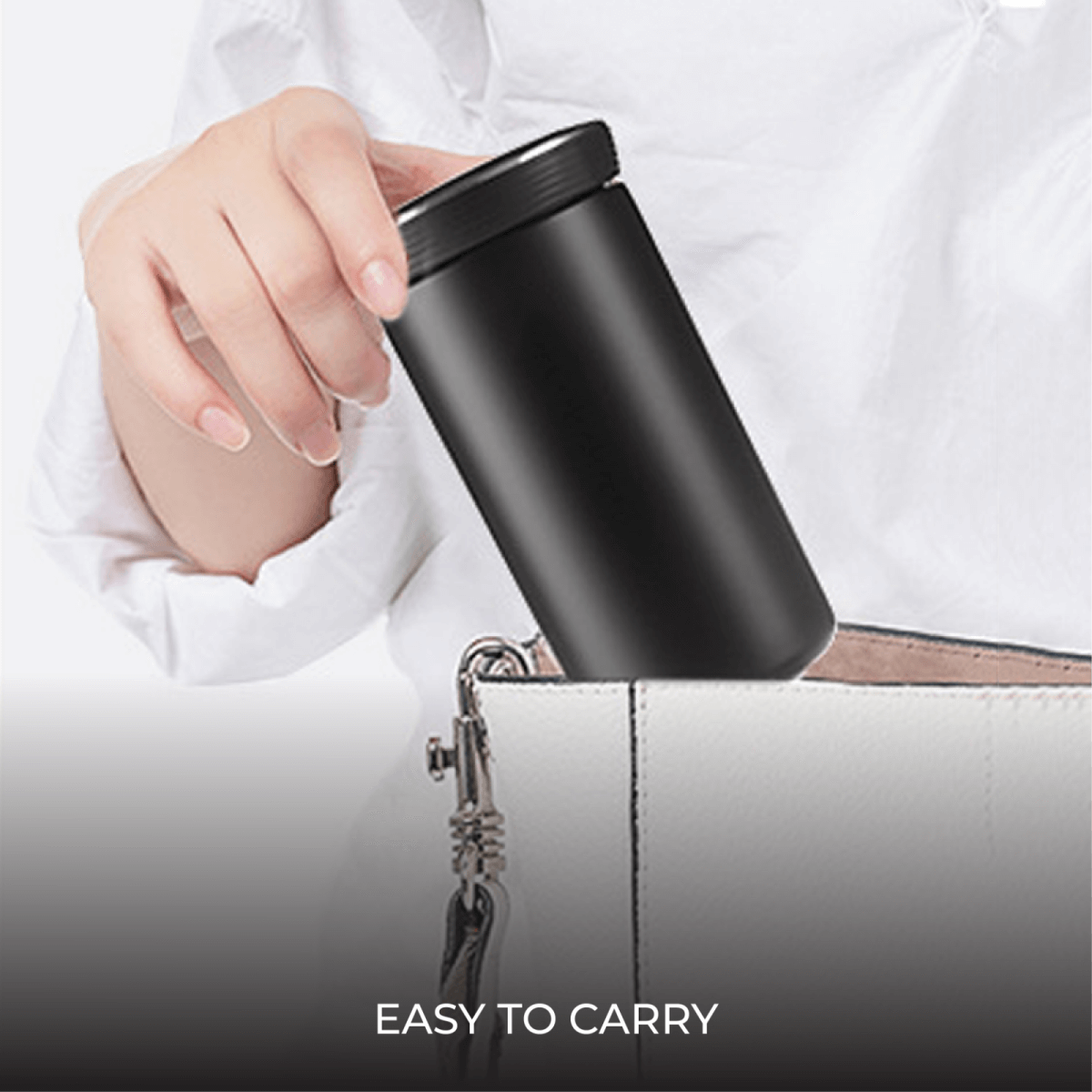Executive 350ml Stainless Steel Vacuum Flask being placed into a handbag, showcasing its portability and design.