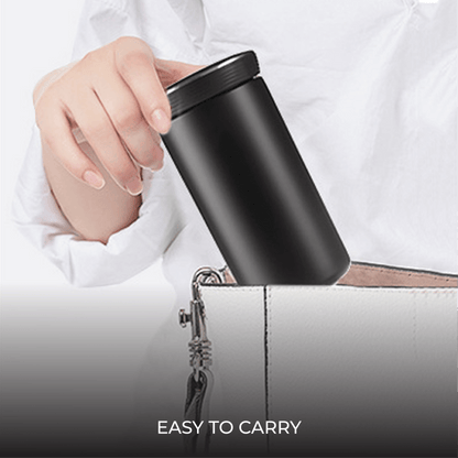 Executive 350ml Stainless Steel Vacuum Flask being placed into a handbag, showcasing its portability and design.