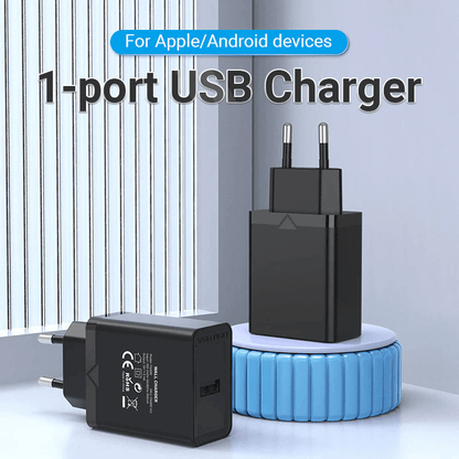 Vention 1-Port USB Wall Charger 12W on a table, ideal for charging Apple and Android devices efficiently.