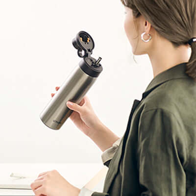 Tiger Vacuum Insulated Bottle MCS-A050 shown in use, stylish design for hot and cold beverages, perfect corporate gift.