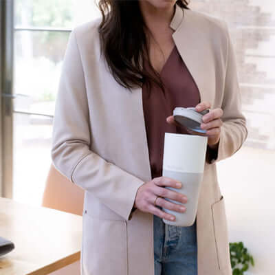 Klean Kanteen Rise 26oz Tumbler (with Flip Lid) held by a woman in a professional setting.
