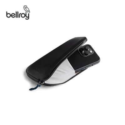 Bellroy All Conditions Phone Pocket Plus Leather with smartphone partially inside, ideal for organizing essentials.
