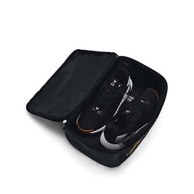 Under Armour Contain Shoe Bag Black with Gold holding sneakers, perfect for athletes and travellers.