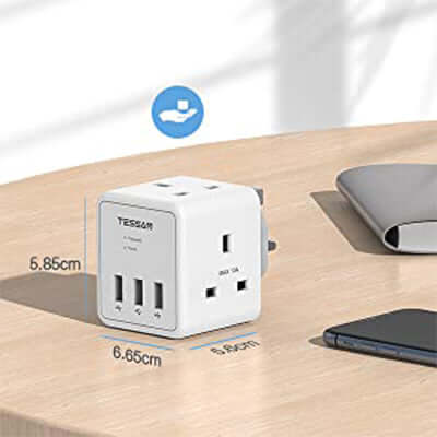 TESSAN 5 in 1 Cube Wall Plug Extension on a wooden table, ideal for charging multiple devices.