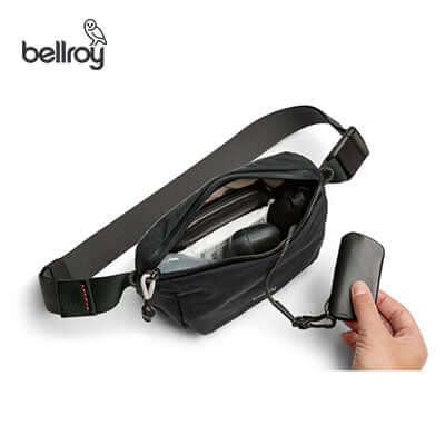 Bellroy Lite Belt Bag with open zipper showcasing internal pockets and key clip for organization.