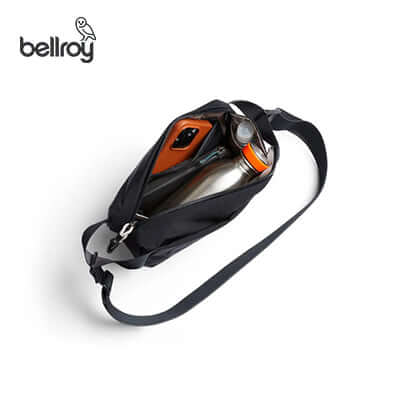 Bellroy Lite Sling Mini Bag showcasing interior with a water bottle and smartphone, ideal for corporate gift.