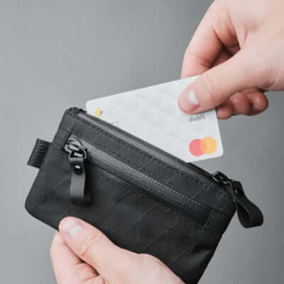 Alpaka Zip Pouch VX21 being used to hold a debit card, ideal for corporate gifts and minimalist travel.