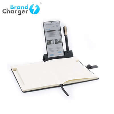 BrandCharger Noty Deluxe Eco Notebook open with a phone and pen stand, perfect for corporate gift use.