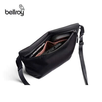 Bellroy Laneway Sacoche Crossbody Bag showing spacious main compartment with devices inside.