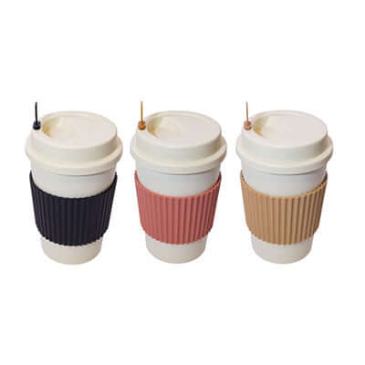 Three 400ml Wheat Straw Mugs with Sleeves in black, pink, and beige for eco-friendly beverages.