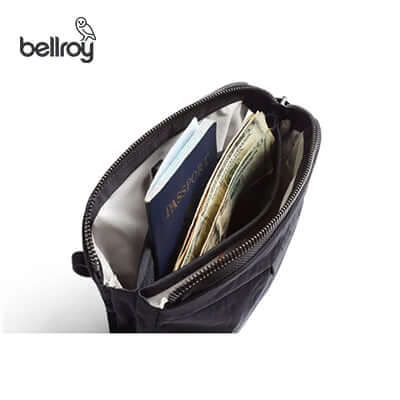 Interior view of the Bellroy Tokyo Side Sling Bag, featuring a passport and cash, ideal for travel.
