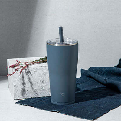ZOJIRUSHI SX-HA72H 0.72L Vacuum Tumbler with Straw on a textured background.